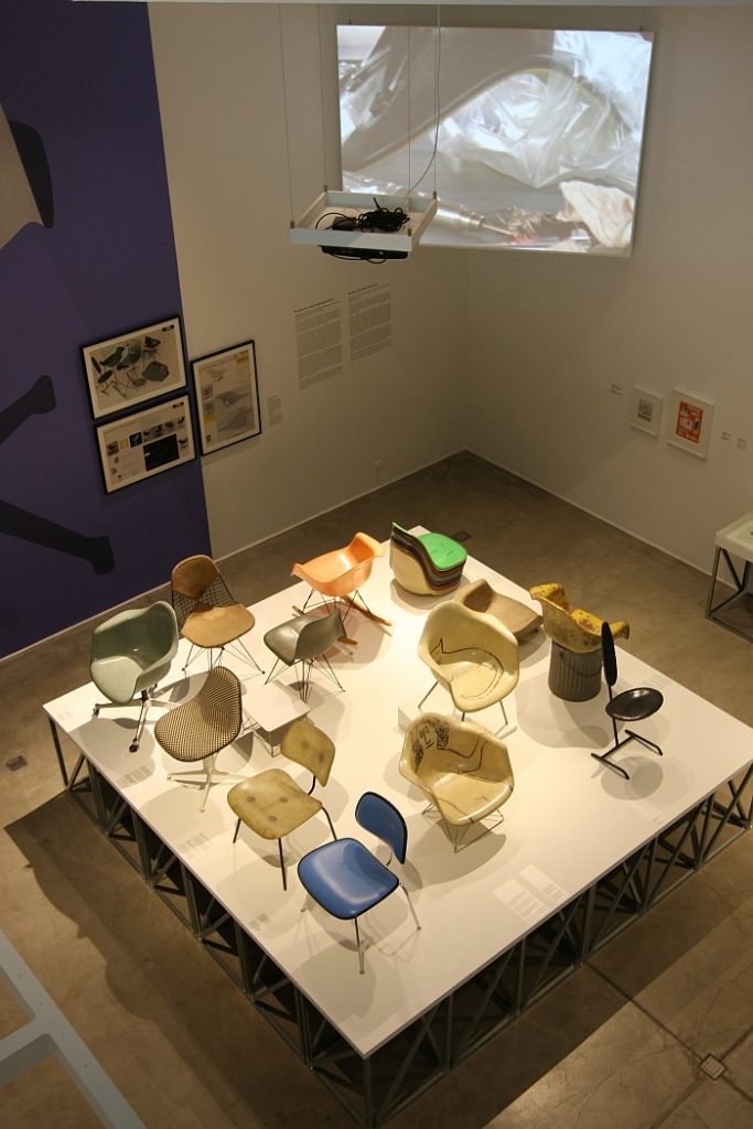 A collection of fibre glass chairs - and a video explaining the production, as seen at Charles & Ray Eames. The Power of Design, Vitra Design Museum