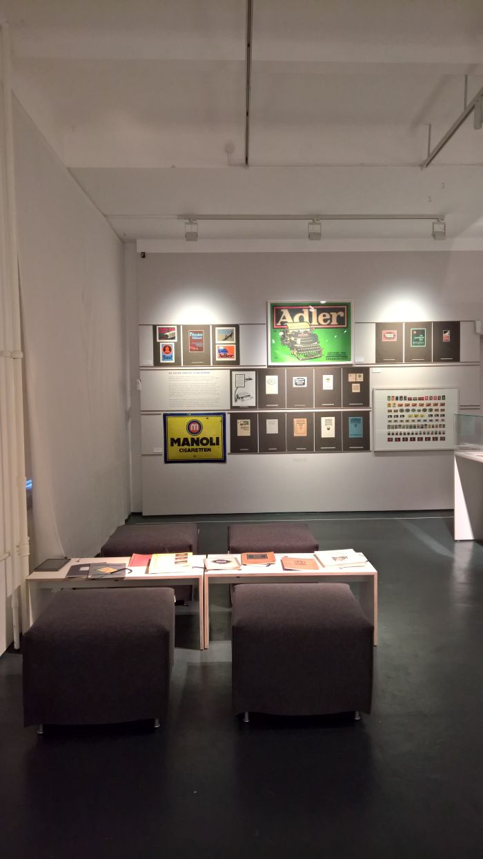 Examples of works by Lucian Bernhard, and the reading corner, as seen at Commercial Design instead of Applied Art?, the Werkbundarchiv – Museum der Dinge Berlin 