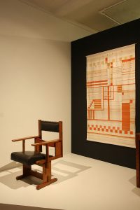 An anoymous chair and weaving by Else Mögelin in a recreation by Studio Aphorisma, as seen at Bauhaus_Sachsen, Grassi Museum für Angewandte Kunst Leipzig