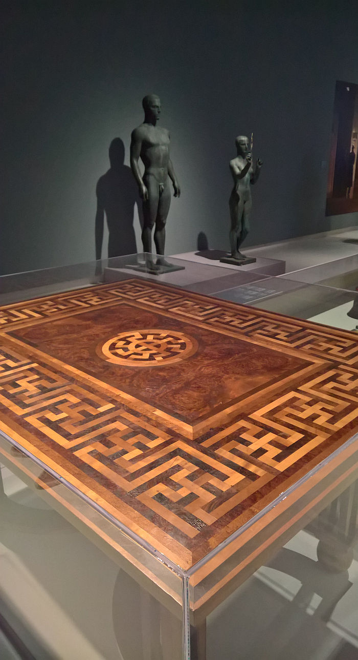 A table by Hermann Burte and the statues Siegerin & Zehnkämpfer by Arno Breker, as seen at Design of the Third Reich, Design Museum Den Bosch
