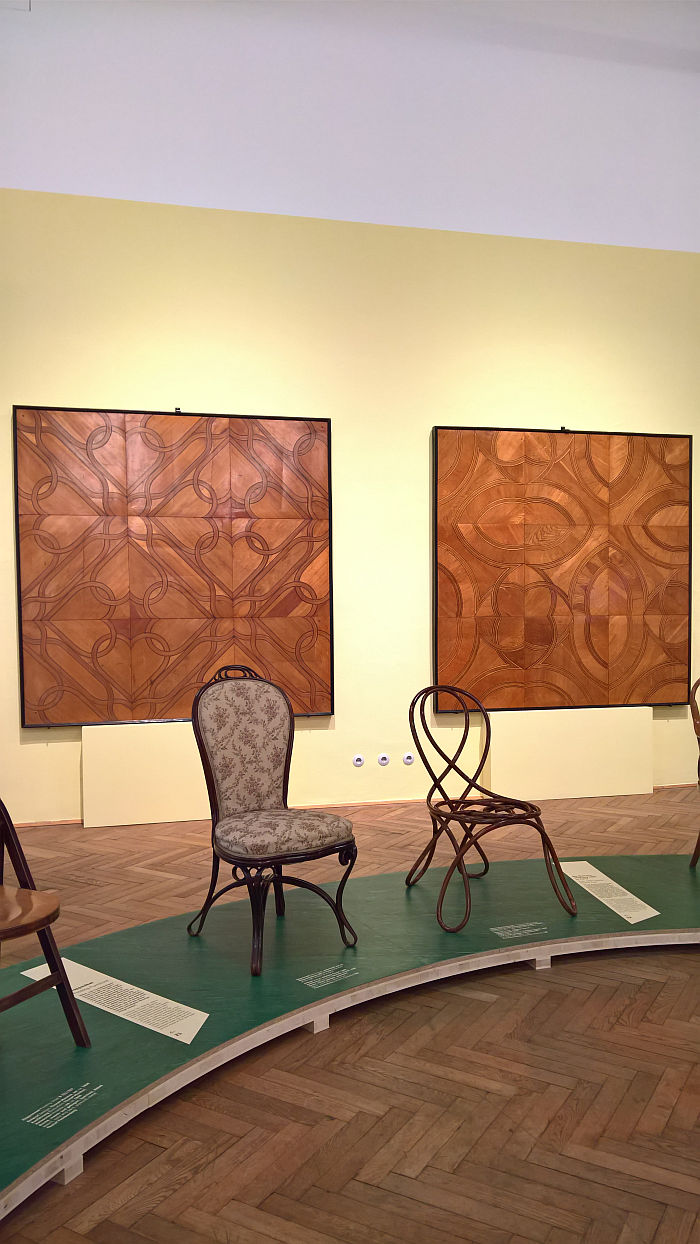 Salon Chair and a bent beech Demonstration Chair as presented by Thonet at the the 1867 World's Fair in Paris, in front of two examples of Thonet parquet work from ca 1855, as seen at Bentwood and Beyond. Thonet and Modern Furniture Design, MAK - Museum für angewandte Kunst Vienna