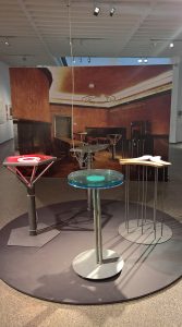 The four bistro tables developed for Cafe "Casino" at documenta 8, and an image of the interior, as seen at Design Gruppe Pentagon, Museum für Angewandte Kunst Cologne