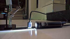 A rechargable USM bike light rechargig in a Haller E USB charger, as seen at USM Haller HomeWork, smow Cologne