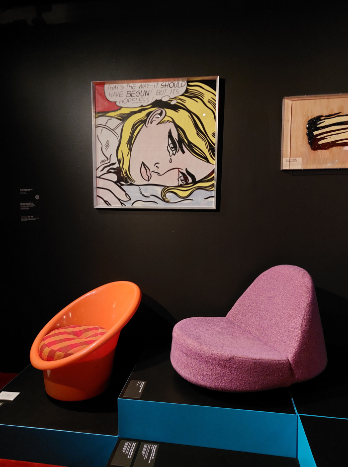 Skopa chair by Ole Gjerløv-Knudsen & Torben Lind (l) and a 1965 low down lounger by Nanna Ditzel below artworks by Roy Lichtenstein, as seen at The Magic of Form - Design and Art, Kunsten Museum of Modern Art, Aalborg