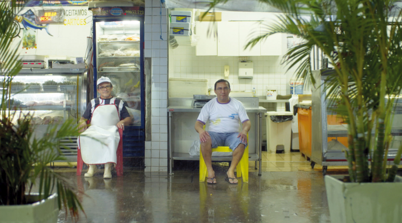 Two gents in a market in Fortaleza, Brazil. On monoblocs. Sadly there are no names associated wit the sitters in the photos in Monobloc, they are as anonymous as the chairs on which they sit. (Photo © Boris Mahlau / PIER 53, courtesy Hatje Cantz)
