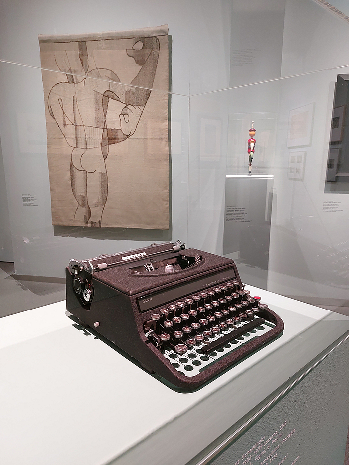 A Studio 42 typewriter for Olivetti by Xanti Schawinsky, with Gino Pollini and Luigi Figini, in discourse with works by Oskar Schlemmer (r) and Johanna Schütz-Wolff (l), as seen at 4 Museums – 1 Modernism, Pinakothek der Moderne, Munich